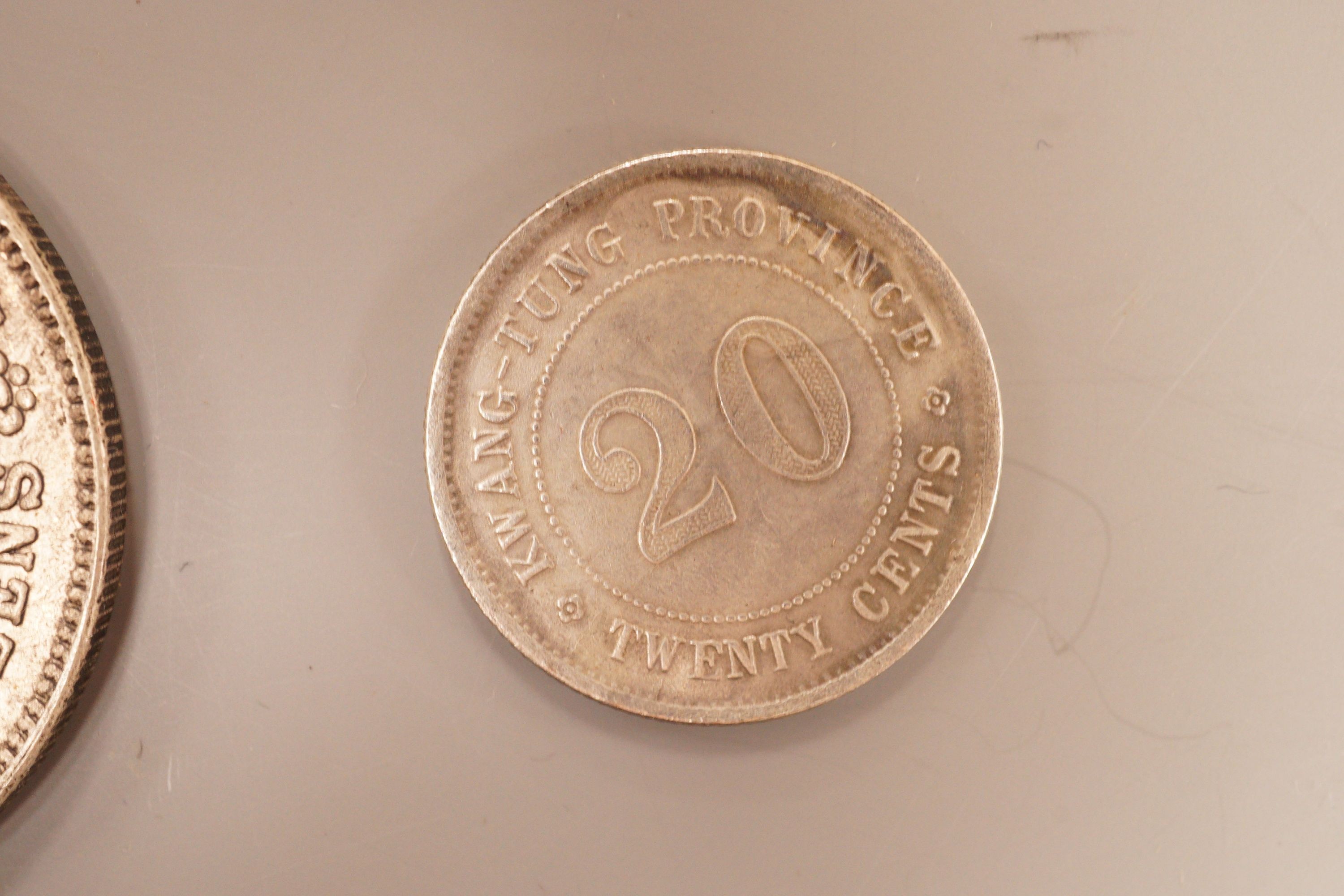 A brass tray, various coins and a rattle dish, 11.5cm diameter
